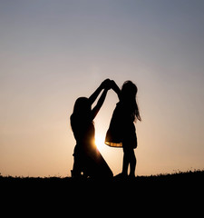 Silhouette happy family at sunset, parents, children Love affair concept Holiday hobby Family activities