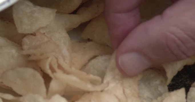 Close Up Of A Pile Of Potato Chips - Hand Picking Chips To Eat