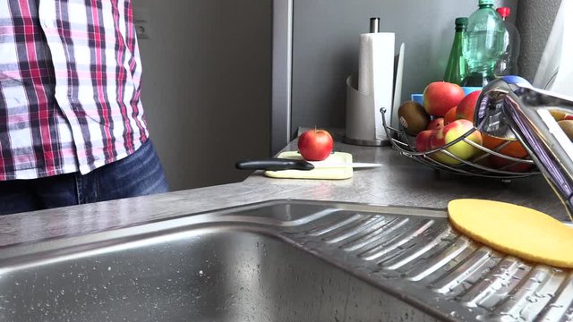 The man is sharpening a kitchen knife