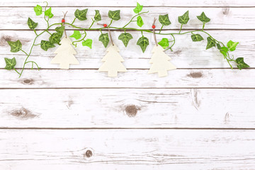 Cute festive Christmas decorations on a vintage whitewash white wood background with space for copy