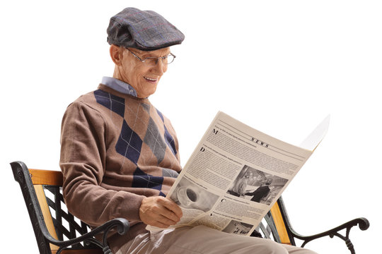 Senior man reading a newspaper with his dog