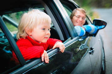 family car travel- cute little girl with father driving on road