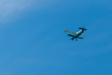 Biplane flying in blue sky