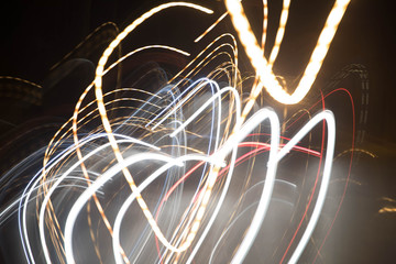 Texture from traces of light fires against a dark background. Motion blur