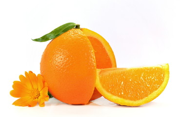 Juicy orange with cut slice and yellow flower isolated on white background