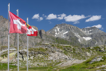 Swiss flags on the San Bernardino pass, Mount San Bernardino, Graubunden, Switzerland.
