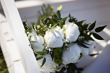wedding bouquet on a white chair 