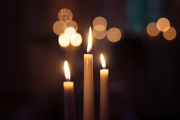 The Candles Burning with bokeh in the background