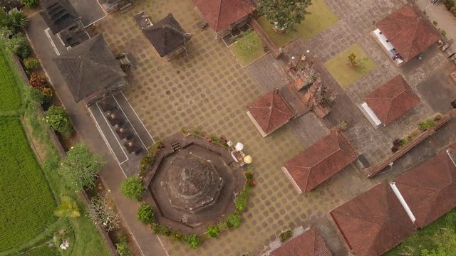 4K aerial flying video of balinese temple among rice fields. Top view. Tropical island of Bali. Beautiful temple.