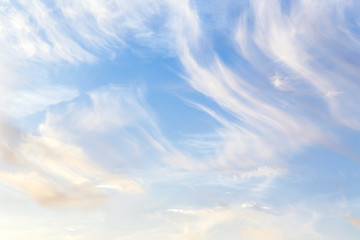 Soft white сirrus clouds against blue sky background