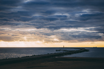 Obraz premium Beautiful pier with lighthouse in sunset