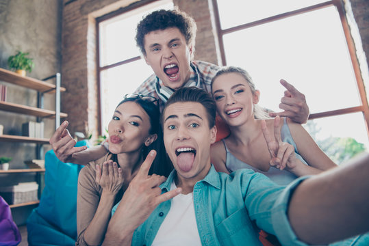 Joyful trandy youths take insane selfie on the front camera smar