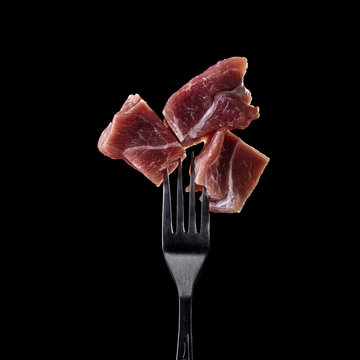 Fresh and raw meat on a fork