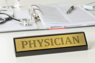 Name plate on a desk with the engraving Physician