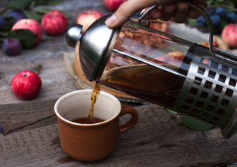 Close up tea is pouring down in a cup