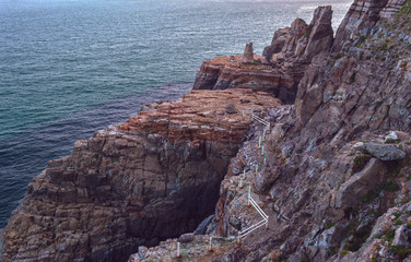 view from above on bay and rugged cliff