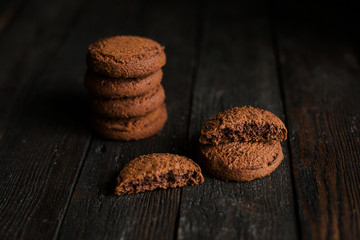 Oatmeal chocolate cookies on dark wooden table
