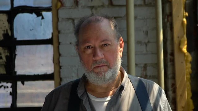 Old Man Looking Into Camera in Slowmo Medium
