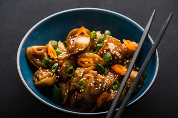 Fried dumplings with soy sauce with pepper and green onions. Asian cuisine