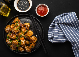 Fried dumplings with soy sauce with pepper and green onions. Asian cuisine