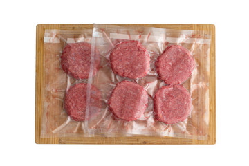 Isolated beef burger patties in a vacuum pack