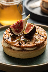 Tarte on sand base with fresh figs, almonds and crispy waffle with almonds and cocoa powder. Fresh Homemade Fruit Tart with berries