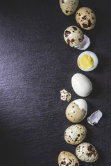 top view of healthy cooked quail eggs on black background