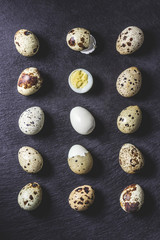 Obraz premium top view of healthy boiled quail eggs on black background