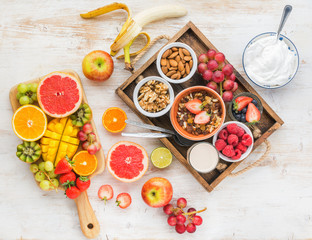 Fototapeta na wymiar Top view of paleo grain free nut and fruit granola served with fruits and berries, nut milk, top view, selective focus