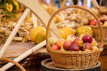 Fresh collection of apples. Nature theme with red apples in a basket on the background of straw. Autumn season
