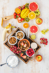Top view of paleo grain free nut and fruit granola served with fruits and berries, nut milk, top view, selective focus