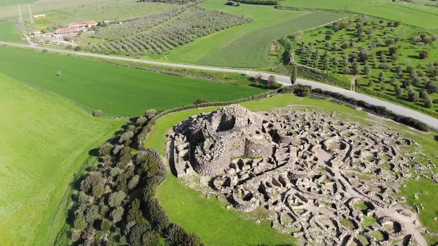 Orbit aerial view of the ruins of beautiful fortress in Sardinia countryside