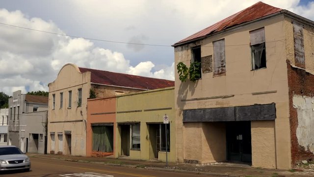 Old abandoned buildings in downtown Natchez, Mississippi, United States of America. Economic crisis and depression with empty businesses, shops, stores and homes