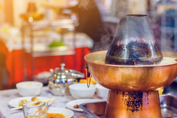Chinese hot pot on a holiday table. Toned