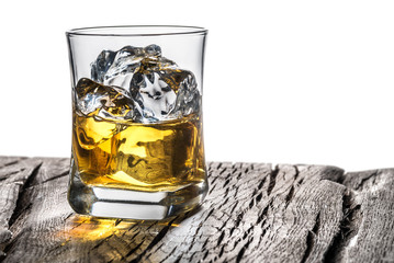 Whiskey glass or glass of whiskey with ice cubes on the table at white background.