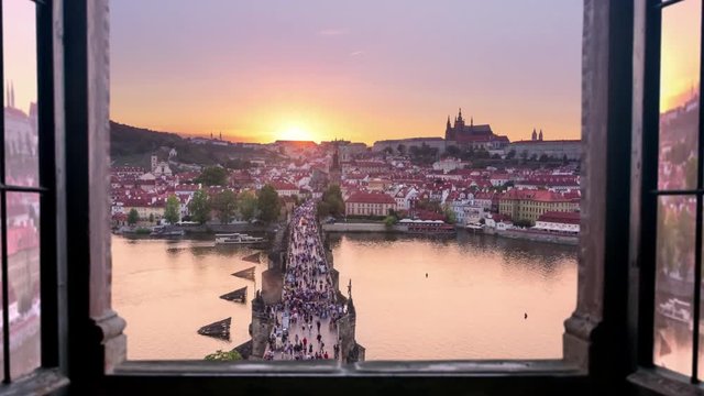 view of prague city skyline charles bridge from a window timelapse day to night