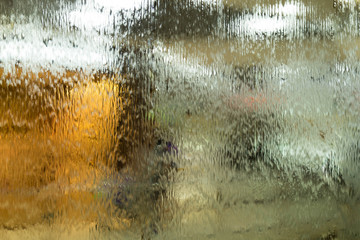 Autumn mood texture for design. Drops of a rain flow down on a smooth surface. Indistinct focus