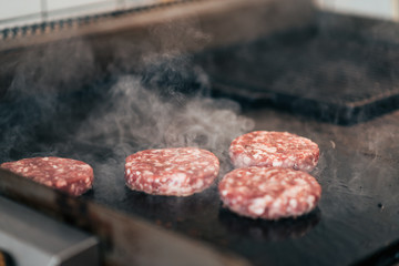 Preparing burger patties.