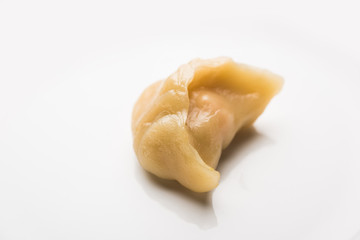 Dumpling momos food from Nepal or Ladakh served with red chilli chutney over moody background. Selective focus