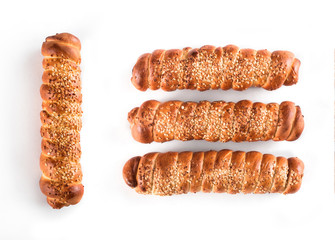 Sausage in the dough with sesame seeds isolated on white background, tasty fast food