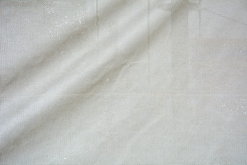 The surface of crumpled dirty grey canvas