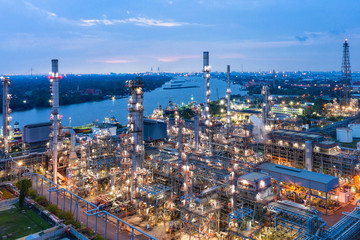 Industrial view at oil refinery plant form industry zone with sunrise and cloudy sky.Oil refinery and Petrochemical plant at dusk,Thailand. Aerial view