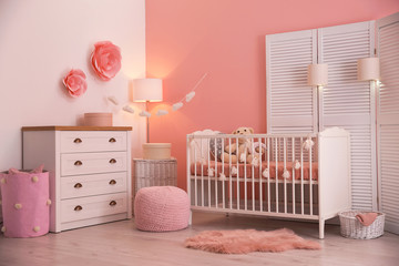 Baby room interior with decorations and comfortable crib