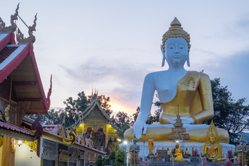 Fototapeta premium Pagoda stupa at Wat-Pratatdoikham (temple name), Chiangmai, Thailand - Buddha statue for praying and worship in Buddhist.