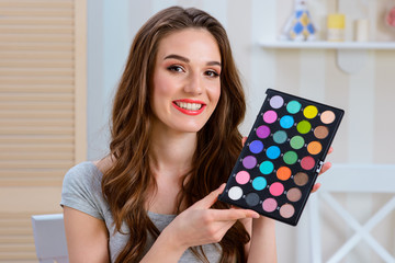 Woman holding makeup set