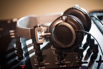 DJ headphones on top of a mixing board