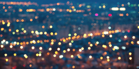 city blurring lights abstract defocused circular bokeh on blue background with horizon at night