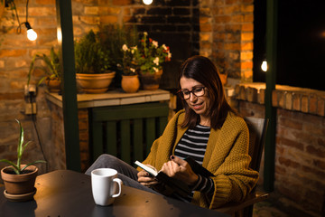 Woman reading book . evening scene.