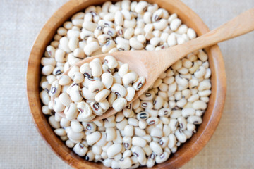 Healthy cereal food background. Natural food cereal have to high benefits to the rail. Above view of Soybean on wooden spoon.