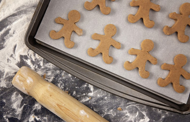 Gingerbread Cookies Being Rolled Out and Cut